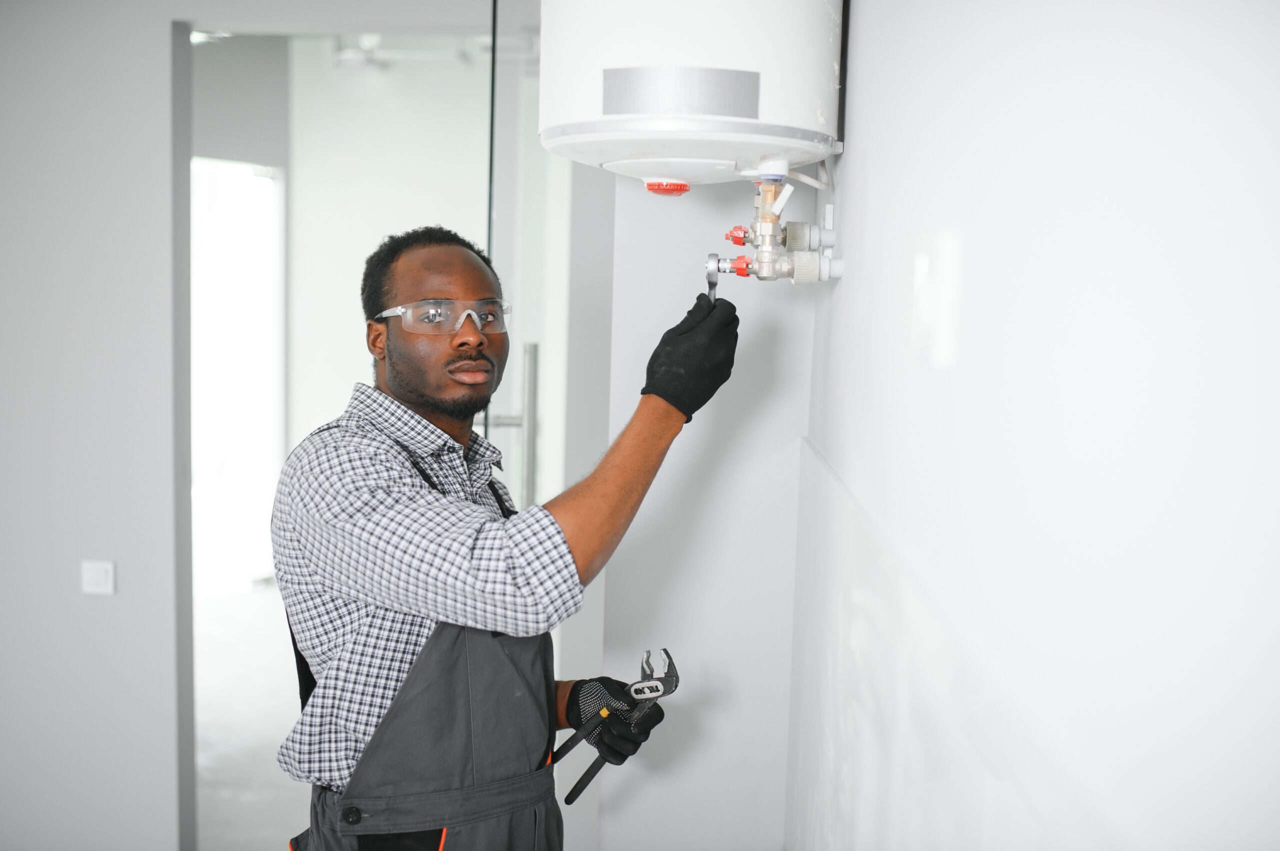 Professional engineer doing a boiler inspection at home.